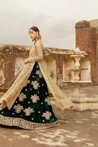 The new season is all about making a statement. Make your moment memorable being a queen in our fawn front open pishwas intensified with voguish sleeves, floral pattern all over and finished with thick embroidered border. The back of the shirt is also enhanced with criss cross patterns filling with beads. Pair it up with bottle green velvet lehenga emphasized with scattered floral motifs and intricate zardozi detailing at the bottom. Dupatta is decorated with vintage froral and finished with embroidered scalloped border on four sides which makes this outfit more beautiful.