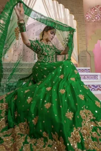 Nothing speaks of femininity and class louder than this green mehndi outfits for bridesmaids. This beautiful outfit comes with a green lehenga which is beautifully embellished with motifs, sprinkled with sequins and it finished with a thick embellished border. The blouse is breathtakingly ornamented with floral bootis which covers every inch of the blouse. The dupatta incorporates beautifully designed scalloped borders and frilled on all four sides. The kora, dabka, tilla, sequins and pearls work are done in the shades of golden.