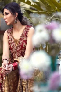 Impeccably on trend, this chic, romantic and oh-so-elegant ensemble is perfect for the one who want to mix vintage touches in with more daring and contemporary designs. Unique craftsmanship and detailed embellishments on the maroon front open shirt, done with golden zardozi. Furthermore the back of the shirt is also emphasized with zardozi work and scattered sequins all over the back. It comprises with golden inner maxi enhanced with maroon embellished applique on the bottom. Pair it up with golden brocade churidar pajama and golden crushed dupatta.