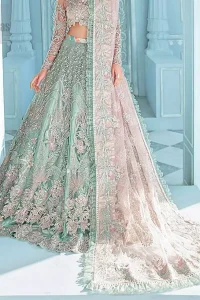 A enchanting amalgamation. This fairytale ensemble is everything that you need to impress everyone. The fusion of rich fabrics intricately designed with floral powdery hue. Precious uncut stones are threaded together with silver zardozi on pastel color palette to give it an enchantingly exquisite look. The illusion neckline blouse is laden with silver kora, dabka details and pair it up with a beautiful lehenga. The lehenga is adorned with colorful chatta patti waist belt and a captivating geometric jaal finished with scattered floral motifs and scalloped hemline. Finish the look with pink dupatta focusing on heavily embellished borders on all four sides to give it a perfect maharani look.