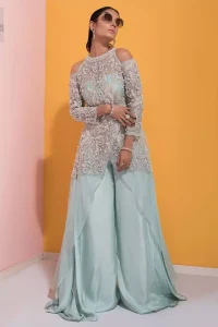 A fashion forward style statement that is contemporary yet chic. This handcrafted remarkable ensemble includes art deco design elements. Unique craftsmanship and detailed embellishments on the pastel green shirt creating delicate yet flamboyant pieces of art in your wardrobe collection. Cold Shoulder sleeves and halter illusion neckline make it more remarkable. To complete the look, go with palazzo pants and organza dupatta sprinkled with sequins all over.