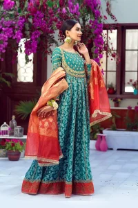 The perfect combination of tradition and class. With a lot of attention to detail, the intricate zardozi work with using glass beading and threads makes the bodice look like nothing but a dream. The tiny floral motifs are also scattered on the bodice. This mehndi outfit is ornamented with vertical embroidered lines and coral applique at the bottom. It comprises with sea green capri pants emphasized with embellished bottom and coral self fabric dupattta. You are all set to make a lasting impact with the divine royalty of this dress.