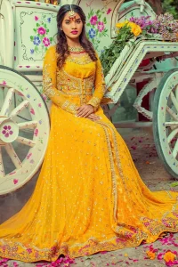 Adorn yourself with this breath-taking mehndi outfit. Be it the next mehndi right after a family festivity. A delicate arrangement of hand embellished tiny floral motifs on the ground and heavily embellished from bodice and neckline with golden and pink zardozi work. The daaman is emphasized with intricate zardozi details and multiple color thread work that gives perfect ending to this outfit. Pair it up with yellow churidar pajama. To complete the look, go with yellow chiffon dupatta scattered with tiny floral motifs and kiran on all four sides.