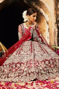 Complete your big day with the perfect dress in our selection of stunning wedding dresses. This artisanal piece is rendered in grace and timelessness. The bodice with a sweetheart neckline is adorned in richly zardozi work with fabulous sparkle. The rest of the dress is beautifully crafted with floral motifs, geometric patterns and embroidered lines along the length. Pair it up with a red lehenga emphasized with multiple colour kora, dabka, tilla and sequins work. Furthermore, the outfit is also adorned with sequins spray all over the ground. Complete the look with an artfully coordinated dupatta having embellished scalloped borders and scattered tiny floral motifs.