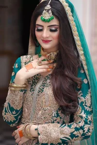 This breathtaking fit and flare wedding dress offers comfort without compromising on style. Featuring beautiful handwork, this outfit has a delicate arrangement of hand-embellished floral patterns with champagne zardozi work along the length. Refined craftsmanship is at its best with a hand embellished belt clenched elegantly at the waistline. It comes with a sea-green lehenga adorned with tiny motifs spray all over the ground and exaggerated with embroidered lace bottom. This outfit is paired up with an organza dupatta with embroidered border to give it a perfect ending.