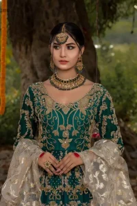 The new season is all about making a statement. Unique craftsmanship and detailed embellishments bring heavenly hued gossamer fabrics to life. Add a charm to your mehndi with an intricately golden embellished bodice and motifs all around the flare on sea green canvas of organza. Daaman is elegantly decorated with embroidered golden floral bootis, sprinkled sequins and beautiful craftsmanship. Pair it up with sea-green sharara having delicate details at the bottom instantly draws attention. To complete the look, go with ivory brocade dupatta.