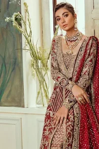 Chic, sleek and undeniably romantic, this beautiful deep red gown might just be the one for you. With pure fabric heavily laden with zardozi and the perfect blend of traditional flamboyance and modern elegance in design, you need to look no further for the perfect look for your special day. The bodice is heavily decorated with zardozi work, the rest of the gown is enriched with floral bootis and finished with the thick embellished bottom. Complete the look with an artfully coordinated lehenga which is ornamented with geometric patterns and captivating back trail design with traditional intricate embroidery. The outfit is coordinated with an organza dupatta finessed with embroidered borders.