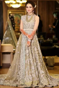 Your graceful personality demands a royal touch, which is why the Fawn Back Train Maxi ensures imperial distinctiveness. As per its highly admirable looks, this exquisite bridal wear is made sleeveless and adorned with exemplary silver embroidery to give it the most majestic vibes. Dresses for whom uniqueness prevails, a halterneck works outstandingly as an icing on a cake. Pure organza is chosen as the graceful fabric for the maxi, whereas the churidar pajama is made with the smoothest raw silk. Not to forget, a final add-up of an elegant net dupatta, and this ravishing attire is all set to dazzle up your Walima.