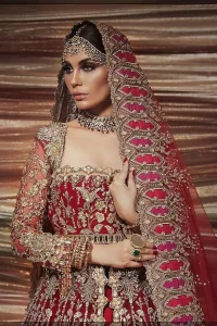 A bride wants to feel as beautiful as she is on her special day, and knowing that our Lehenga was the final decision in that, it is priceless. This bold and iconic bridal ensemble with its dainty flutter silhouette leaves us feeling whimsical, romantic, and even a bit enchanted. This front open pishwas is laden with silver and golden zardozi work, a beautifully crafted waist belt and floral embroidery patterns. The dress is even more enhanced with the ruffled bottom. It is coordinated with a beautiful dupatta with thick matha Patti borders along the length and an intricate beautiful border on the rest of the two sides.