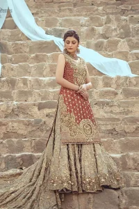 An uplifting look for any formal occasion. This wedding outfit is emphasized with zardozi work. The shirt is beautifully decorated with embroidered neckline, a central geometric motif on the border, and scattered tiny floral motifs all over the ground. Pair it up with a pastel green back train lehenga enhancing with the art of classical heritage showcasing the craftsmanship of zardozi work, multiple colors embroidery, and finishing with scalloped borders. The outfit is coordinated with a net dupatta with hand-embroidered borders on all four sides and sequins spray on the ground.