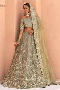 When extreme beauty is your identity, the Olive Green Off Shoulder Blouse Lehenga makes sure it boosts your gorgeousness with its much more attractive elegance. This paragon of exquisiteness is designed with three-quarter sleeves, making sure it meticulously matches its objective. The silver and golden embroidery serve as the cherry on top, while the stunning floral motifs do not fail to catch all admiring eyes on the finest details of adornment on the dress. Finest organza as always is the prime choice for an attire so meritorious and the concluding marvellous net dupatta prepares this laudable dress to brighten up your Walima ceremony.
