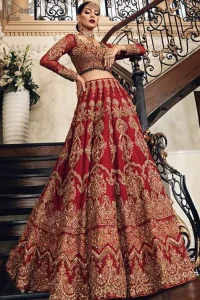 Poise, Beauty, and Charm. Feel pampered in this finely handcrafted celestial-inspired ensemble, deftly ornamented with intricate hand-embroidery. Fitted red blouse with cross-check pattern work and solid embroidery. Pakistani bridal dress comes with a large flare lehenga having multiple panelled embroideries.   Pure Organza dupatta has heavy four-sided borders and cross-checks pattern embroidery. 