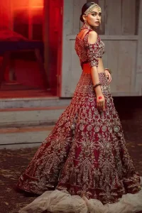 Maroon Pakistani bridal wear half blouse and lehenga comes with dupatta. Deep red half blouse choli along with same colour Lehenga of Organza Fabric with Golden-Ivory Embroidery is Everything. For a Bride planning, some exceptional outfit here comes the fully embellished, geometrical shapes having half sleeves for her Reception. The V-Neckline unifies the whole outfit with fully sprayed Tilla, Dabka work with floral motifs on Blouse Choli, Lehenga and Net Dupatta of Organza Fabric. The Lehenga has finished edges with full flare and fixed waist belt with a side zip closure along with dupatta of same deep red colour with heavy full embellished four borders.