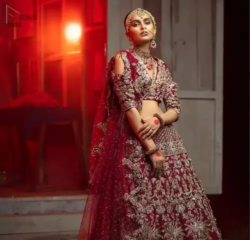 Maroon Pakistani bridal wear half blouse and lehenga comes with dupatta. Deep red half blouse choli along with same colour