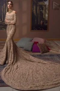 Take a step towards refreshing your wardrobe with our fawn off-shoulder back train mermaid gown. The outfit is perfected with loaded golden and silver embroidery, elevated by vibrant floral motifs and adorned in a fawn embellished with golden work detailing around the strapless neckline. All over, this undeniably elegant attire will elevate your style. Feel the dreamy vibes with this heavenly combination of fawn off-shoulder back train mermaid gown and cigarette pants adorned with floral embroidery, followed by a graceful net dupatta. Making your evening parties more beautiful.