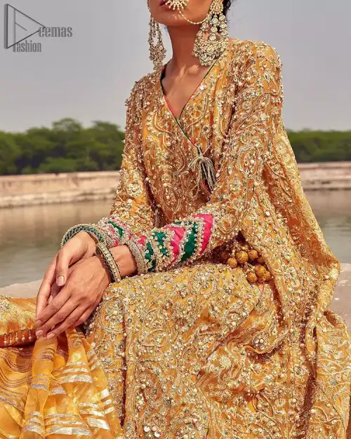 A beautiful touch of light golden embroidery embellished with sparkling pearls follows a fascinating churidar pajama, finally concluding the dress.