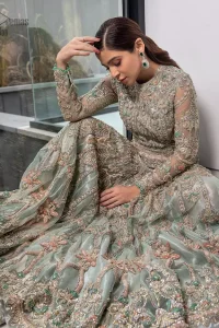 Pastel Green Large Flared Anarkali - Pakistani Wedding Gown. The bottom part of this amazing outfit comprises a lehenga with Fixed Waist Belt With Side Zip Closure. The Ivory i.e silver general embroidery with floral motifs and multicolour embroidery network on organza with finished embellished edges has its own impact. The Dupatta carried sideways have also tissue fabric with embellished four sides and finished edges. Whole this embellishment, the gorgeousness of the costume comes to the spectator noticing eye because of another unifying feature of this outfit that it is 100% imported, pure highest quality fabric.