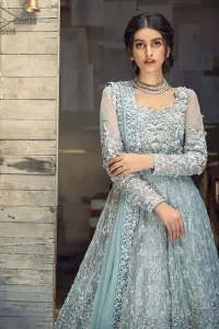 Framed in a beautiful combination of Powder blue colour in a gorgeous criss-cross pattern over the neckline with organza fabric beautifying the whole combination with blue powder colour and floral motifs and climber network making it fully embellished, the gorgeously beautiful adorned dress seems prominent as the outstanding features of the extravagant beautiful costume stands out including the unifying plus the fabulous combo. Of the modern stitching method in the blouse having a full Maxi style along with fixed waist belt in which the organza fabric having dupatta with the heavy cool colour of powder blue same touch with dabka work with heavy fully embellished four borders with finished edges is beautifully set. The whole network of climber and flowery motifs with the same colour touch has gorgeous embellishment which includes kora, dabka, stones, sequins, beads, silk threads and Swarovski crystals along with the very unique aspect i.e 100% pure highest quality imported fabric authenticity to be worn on your big days such as Waleema. The full sleeves give the complete touch of the costume with conventional embroidery. The bottom comprising of double flare lehenga consists of the very unique and beautiful climber rows on the fabric i.e Katan Banarsi Jamawar with Fixed waist belt with side zip closure and fully embellished climbers with Powder blue colour mesmerizing the whole outfit. Powder Blue Maxi - Banarsi Jamawar Lehenga - Engagement Wear