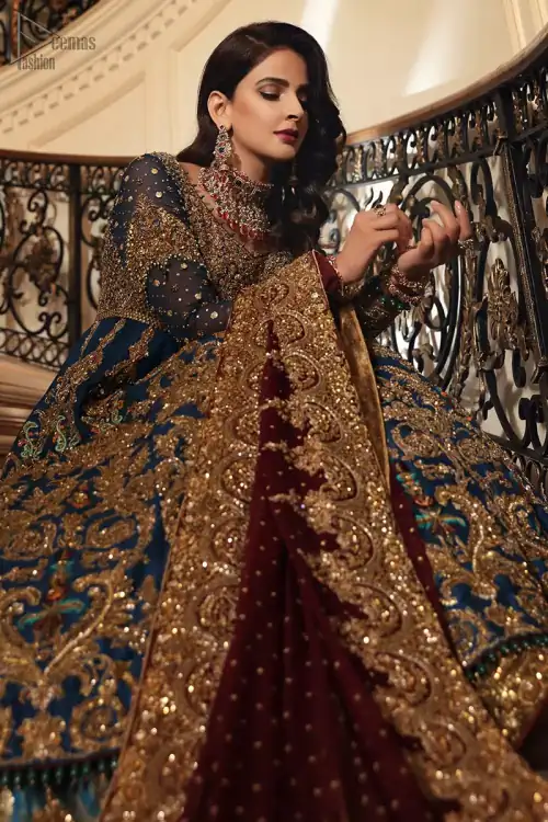 Style exquisitely with Teal Lehenga Pishwas on your Nikkah or Walima. The dress accompanies a fascinating Maroon dupatta.