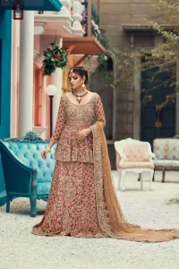 Red Peplum and Lehenga with Rust Net Dupatta. It features a highly remarkable back train and is decorated with fascinating criss-cross patterns. charming as it is, the very exquisite dress code includes a mesmerizing organza peplum, a gorgeous organza lehenga and not to forget, the traditional touch with a net dupatta. 