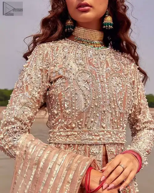 the dress with a tissue dupatta and graceful palazzo pants makes you the center of attention on your big day. Peach