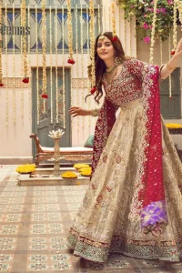 It's distinctive how the new-gen brides are welcoming red and beige shades for their bridal outfits as well. So Welcome your guest to this charming beige lehenga. The three quarter-sleeved Red Blouse  got it all for you. In addition to this, the Beige lehenga have embellished border embroidery and floral embroidery in dabka, kora work that give the stunning look. Furthermore, it is enhanced with embroidered applique bottom. The organza red dupatta that has a scalloped applique border all around the edges makes the look complete and comprehensive.