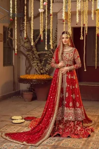 Some pieces are specifically hand-crafted to speak to your heart just like this red front open Pishwas. The pishwas with a boat-shaped neckline is adorned in luxuriously zardozi work with fabulous sparkle. The rest of the dress is beautifully crafted with floral motifs, sequins spray, and embroidered lines along the length. Set it up with a red  back train lehenga emphasized with kora, dabka, tilla and sequins work. Complete the look with an artfully coordinated dupatta having embellished sequins all over and scattered tiny floral motifs.