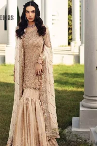 Opt for a versatile outfit for your Nikkah that is the perfect amalgamation of splendid colours, deluxe fabrication, and exquisite profile as well. Satiate your soul with extraordinary ensembles from this fawn short shirt gharara of DeemasFashion outfits. The round neckline of the short shirt is just amazing when combine with full sleeves. Further, it is highlighted with antique embroidery that includes tilla, kora, and dabka work. Pair up it with fawn gharara made with pure Katan banarsi jamawar fabric just to grant you a super aesthetic look. Complete this outfit with a fawn dupatta that is embellished with a four-sided embellished border and kiran lace as well.
