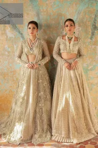 With a touch of Divine. A stunning ivory blouse is laboriously frosted with meticulously detailed hand embellishment with kora, dabka, tilla and pearls all over. The sweetheart neckline of the blouse and full sleeves together gives a so romantic look to any bride. In addition to this, it is systemized with the same colour frilled lehenga which is laden with the same colour embroidery that gives a magical stream of tilla, dabka and pearls. Finish this ivory article with the same colour dupatta that is heavily embellished with four-sided handsome borders and sequins sprayed all over to enhance the feeling of joy. 