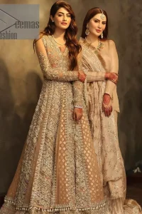 Its lustrous, lush and lavish in every sense of the word with its dazzling nude peach base. The nude peach multiple panel frock is amazing for your walima day. The V shape neckline is heavily embellished with embroidery. Further, this aesthetic nude peach frock is enhanced with silver pearls, tilla and dabka work. It is prominent with full sleeves that give a soothing effect to this article. It is complete in its pleasing loudness with an equal nude peach sharara that is adorned with silver embroidery just to fulfil the fairy dream of every bride. 