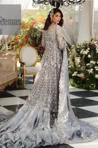 Walking into a new chapter of your life with the joy of togetherness and the magic of love. DeemasFashion presents a silver-grey maxi for your walima day that is handsomely adorned with a silver embroidery that comprises tilla, kora, dabka and crystal work. It is featured with a round neckline and full sleeves that grant you the feeling of joy. Parten this with back train shimmery lehenga which is beautifully organised with the same colour frill that enhances the overall charms of the unique article. Carry this article on your walima day and surprise your loved ones with this fairy look. 