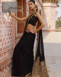 Every saree tells a story! Black is always the reason behind any smile at parties. DeemasFashion also presents a formal saree in black that you can wear at any function or party. The black blouse having sleeveless and strap neckline gives you so soothing and romantic look. Further, the simplicity of the blouse enhances the beauty of the outfit. It comes with a pure black saree which is ornamented with golden embroidery. It is highlighted with tilla, kora, and dabka work on borders. The pallu of the saree is also prominent with golden embridery.