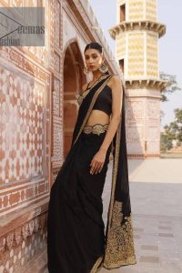 Every saree tells a story! Black is always the reason behind any smile at parties. DeemasFashion also presents a formal saree in black that you can wear at any function or party. The black blouse having sleeveless and strap neckline gives you so soothing and romantic look. Further, the simplicity of the blouse enhances the beauty of the outfit. It comes with a pure black saree which is ornamented with golden embroidery. It is highlighted with tilla, kora, and dabka work on borders. The pallu of the saree is also prominent with golden embridery. 