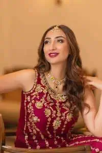 The golden pasting on a glamorous magenta canvas. The beautiful attire is presented that begins with a magenta long shirt which is attractively furnished with golden embroidery. It is spotlighted with tilla, dabka, kora and zardozi to make your event blazing and astonishing. In addition to this, it is attractively featured with a round neckline and sleeveless style. The following magenta long shirt is paired up with purple trousers that's border is again embellished with golden embroidery that gives a unique piece of style in every function.