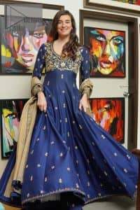 Hues of blues make a funky yet amazing pattern on amazing events. DeemasFashion introduces a navy blue outfit. Starting this article with a navy blue multiple panel frock which is ornamented with golden embroidery. The pattern of embroidery begins with the round neckline which is handsomely embellished with tilla, dabka, kora and Kundan. It is further prominent with full sleeves. The rest of the frock is decorated with floral motifs in a golden hue. The following frock comes with a golden dupatta to complete the admiring look on any day or night event.