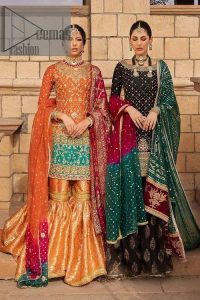 Be a happy and charming bride just like orange is a happy colour. DeemasFashion presents you with an orange short shit that is laboriously embellished with golden embroidery. The base of embroidery starts from the boat shape neckline of the shirt that giving a fully artistic look. In addition to this, it is enhanced with tilla, dabka, kora and Kundan work. The half sleeves of the dhirt also enhance the beauty of the handwork. It is coordinated with orange gharara that is perfect for entimate evening of your Mehandi. Finish this outfit with Pink dupatta that is adorned with ravishing details, the embellished borders represent the craftsmanship of DeemasFashion.