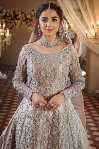 Amplify your style on your Walima day in this stunning light color. DeemasFashion presents the super handsome rose gold outfit for you. First of all, which includes back train maxi in the rose gold colour. It is prominent with the silver embroidery that is encrusted with pearls, silver crystals, kora, dabka and sequins all over highlighting floral patterns. Further, it is emphasized with boat shape neckline and full sleeves that increase the opulent statement of the outfit. It is organized with rose gold sharara which is also embellished with heavy silver embroidery to make your day super dazzling. Finish this look with the rose gold dupatta that is accentuated with sequins and booti spray all over and adorned with a four-sided matha Patti border. 