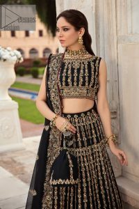 Black is the second way to show romanticness. This black article is attractively rendered with golden embroidery in which details speak for themselves. First of all the blouse in the article is as amazing as in the picture. It is further prominent with tilla, dabka, crystal and kora to enhance the power of black. The boat shape neckline also increases the beauty of the blouse when comes with a sleeveless style. Further, it is paired up with a black can-can lehenga which is heavily embellished with golden embroidery. Complete this look with a black dupatta which is again rendered with four-sided borders and floral motifs all over.