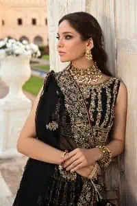 Black is the second way to show romanticness. This black article is attractively rendered with golden embroidery in which details speak for themselves. First of all the blouse in the article is as amazing as in the picture. It is further prominent with tilla, dabka, crystal and kora to enhance the power of black. The boat shape neckline also increases the beauty of the blouse when comes with a sleeveless style. Further, it is paired up with a black can-can lehenga which is heavily embellished with golden embroidery. Complete this look with a black dupatta which is again rendered with four-sided borders and floral motifs all over.