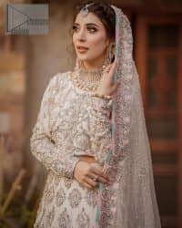 Ivory is effortlessly snappy and fun with the essence of pop. Introducing the Walima outfit for the happiest bride. Starting the outfit with an astonishing blouse having golden embroidery which includes kora, dabka, tilla and Kundan to make this outfit a unique piece of fun. Further, it is enhanced with boat shape neckline with intimate full sleeves. It is beautifully organized with a can-can lehenga in the same colour to embrace the magic of love. The floral embroidery on the lehenga gives a super aesthetic feeling to the outfit. Finish this look with the handsome dupatta in the same hue having a four-sided embellished border and sequins sprayed all over to show the essence of pop.