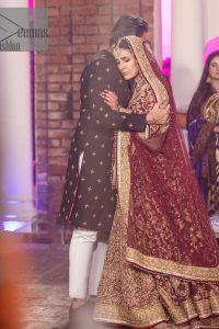 Take me to your heart, for it's there that I belong. A pure outfit base in maroon as a canvas to meticulously designed golden bloomings all over to show the real-time magic of tilla, kora, dabka and zardozi. The round neckline of the traditional pishwas highlighted the incrusted beauty of the outfit. Further, the full sleeve of the following pishwas is wearable art on your big day. It is systemized with a heavy lehenga to give you a more traditional look. Complete this maroon outfit with a dupatta in the same hue having four-sided embellished borders and sequins sprayed all over to show the colour of love.