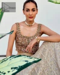 The perfect outfit for walima to enhance your glow. Starting this article with a dream rust blouse having a strap neckline and prominent sleeveless style to embrace the romantic culture. The following blouse is fully embellished with golden embroidery that is prominent with tilla, dabka, kora, pearls and sequins spray to fulfil your dreamy look. It is coordinated with an ivory can-can lehenga whose border is again rendered with golden embroidery and sequins sprayed all over to continue the look. Complete this outfit with a rust dupatta which is embellished with four-sided borders and sequins sprayed all over to enhance the glow of the bride.