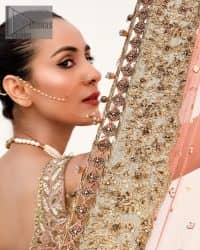 The perfect outfit for walima to enhance your glow. Starting this article with a dream rust blouse having a strap neckline and prominent sleeveless style to embrace the romantic culture. The following blouse is fully embellished with golden embroidery that is prominent with tilla, dabka, kora, pearls and sequins spray to fulfil your dreamy look. It is coordinated with an ivory can-can lehenga whose border is again rendered with golden embroidery and sequins sprayed all over to continue the look. Complete this outfit with a rust dupatta which is embellished with four-sided borders and sequins sprayed all over to enhance the glow of the bride.