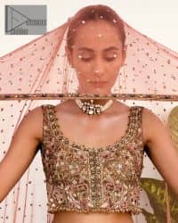The perfect outfit for walima to enhance your glow. Starting this article with a dream rust blouse having a strap neckline and prominent sleeveless style to embrace the romantic culture. The following blouse is fully embellished with golden embroidery that is prominent with tilla, dabka, kora, pearls and sequins spray to fulfil your dreamy look. It is coordinated with an ivory can-can lehenga whose border is again rendered with golden embroidery and sequins sprayed all over to continue the look. Complete this outfit with a rust dupatta which is embellished with four-sided borders and sequins sprayed all over to enhance the glow of the bride.