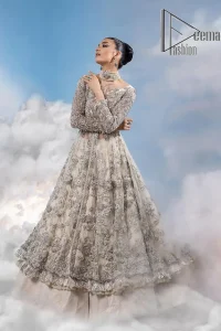 The mind wears the colours of the soul, as a beige of those of his master. Starting this nikah outfit with a beige frilled maxi which is laboriously hand-rendered with silver embroidery to fulfil the fairy dream of every bride. Furthermore, it is enhanced with tilla, dabka, kora and crystal which magnifies the beauty of this nikah outfit. The illusion neckline looks as amazing when comes with full sleeves as the moon with stars. The maxi of this nikah outfit is systemized with a lehenga in the same colour which is proof of uniqueness. Complete this nikah outfit with a dupatta in the same colour having a four-sided embellished border and sequins sprayed all over.    