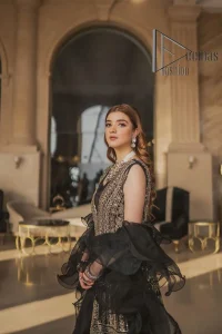 Wear black in-depth to lead colourful lives. DeemasFashion presents black party wear which includes a front open maxi having light golden embroidery which is beautifully decorated with tilla, dabka, kora and Kundan. Further, it is prominent with sleeveless style and sweetheart neckline to make you a memorable girl of the event. The part wear is organized with a frilled lehenga which is a unique core piece. Complete this party wear with a dupatta in the same colour to boost your day with black.