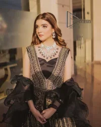 Wear black in-depth to lead colourful lives. DeemasFashion presents black party wear which includes a front open maxi having light golden embroidery which is beautifully decorated with tilla, dabka, kora and Kundan. Further, it is prominent with sleeveless style and sweetheart neckline to make you a memorable girl of the event. The part wear is organized with a frilled lehenga which is a unique core piece. Complete this party wear with a dupatta in the same colour to boost your day with black.