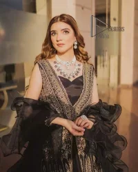 Wear black in-depth to lead colourful lives. DeemasFashion presents black party wear which includes a front open maxi having light golden embroidery which is beautifully decorated with tilla, dabka, kora and Kundan. Further, it is prominent with sleeveless style and sweetheart neckline to make you a memorable girl of the event. The part wear is organized with a frilled lehenga which is a unique core piece. Complete this party wear with a dupatta in the same colour to boost your day with black.