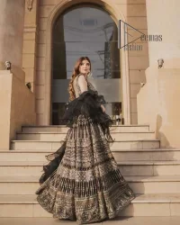 Wear black in-depth to lead colourful lives. DeemasFashion presents black party wear which includes a front open maxi having light golden embroidery which is beautifully decorated with tilla, dabka, kora and Kundan. Further, it is prominent with sleeveless style and sweetheart neckline to make you a memorable girl of the event. The part wear is organized with a frilled lehenga which is a unique core piece. Complete this party wear with a dupatta in the same colour to boost your day with black.