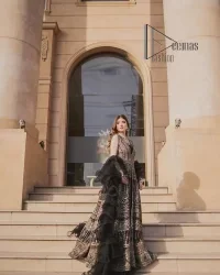 Wear black in-depth to lead colourful lives. DeemasFashion presents black party wear which includes a front open maxi having light golden embroidery which is beautifully decorated with tilla, dabka, kora and Kundan. Further, it is prominent with sleeveless style and sweetheart neckline to make you a memorable girl of the event. The part wear is organized with a frilled lehenga which is a unique core piece. Complete this party wear with a dupatta in the same colour to boost your day with black.